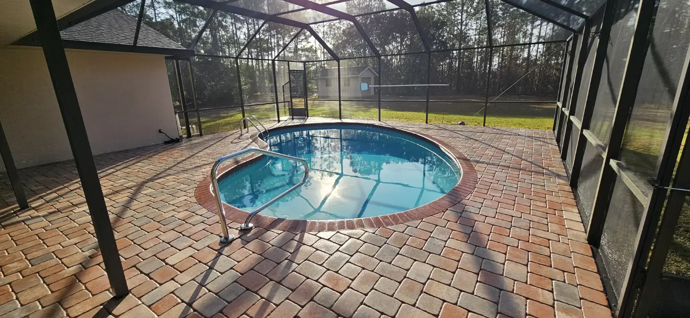 Sealed pavers around a screened pool